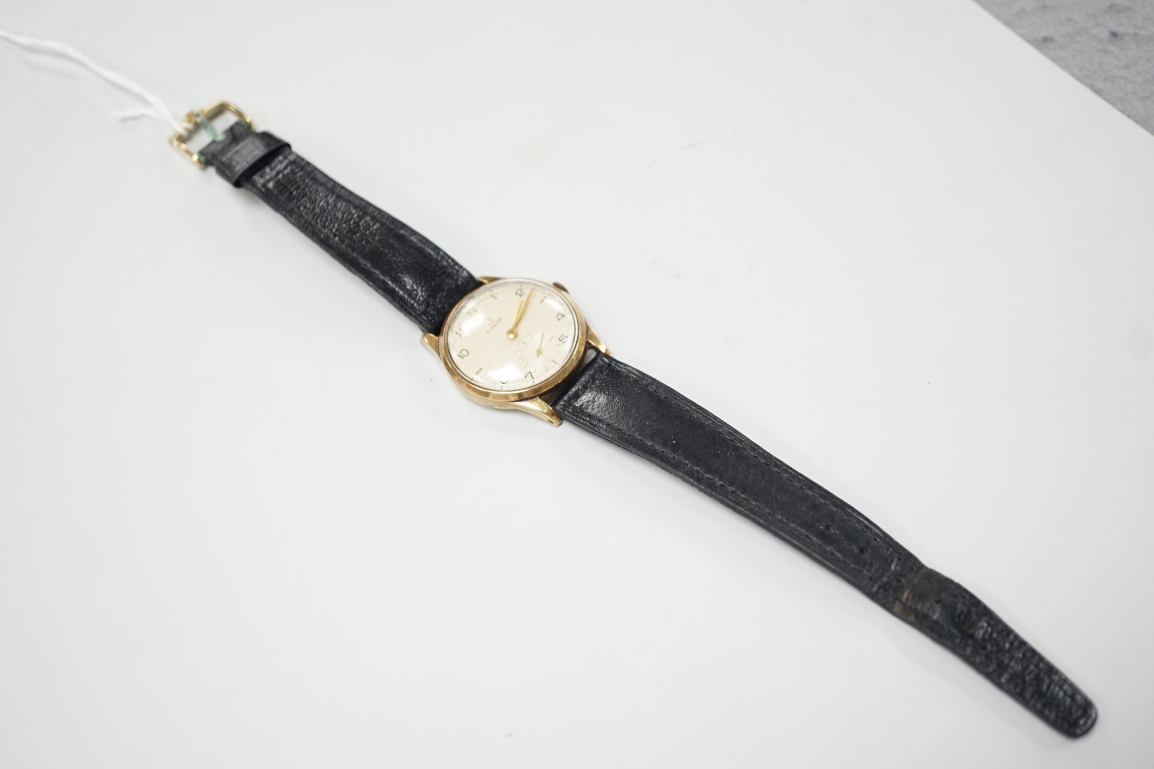 A gentleman's 1950's 9ct gold Omega manual wind wrist watch, movement c.265, case diameter 34mm, on later associated leather strap.